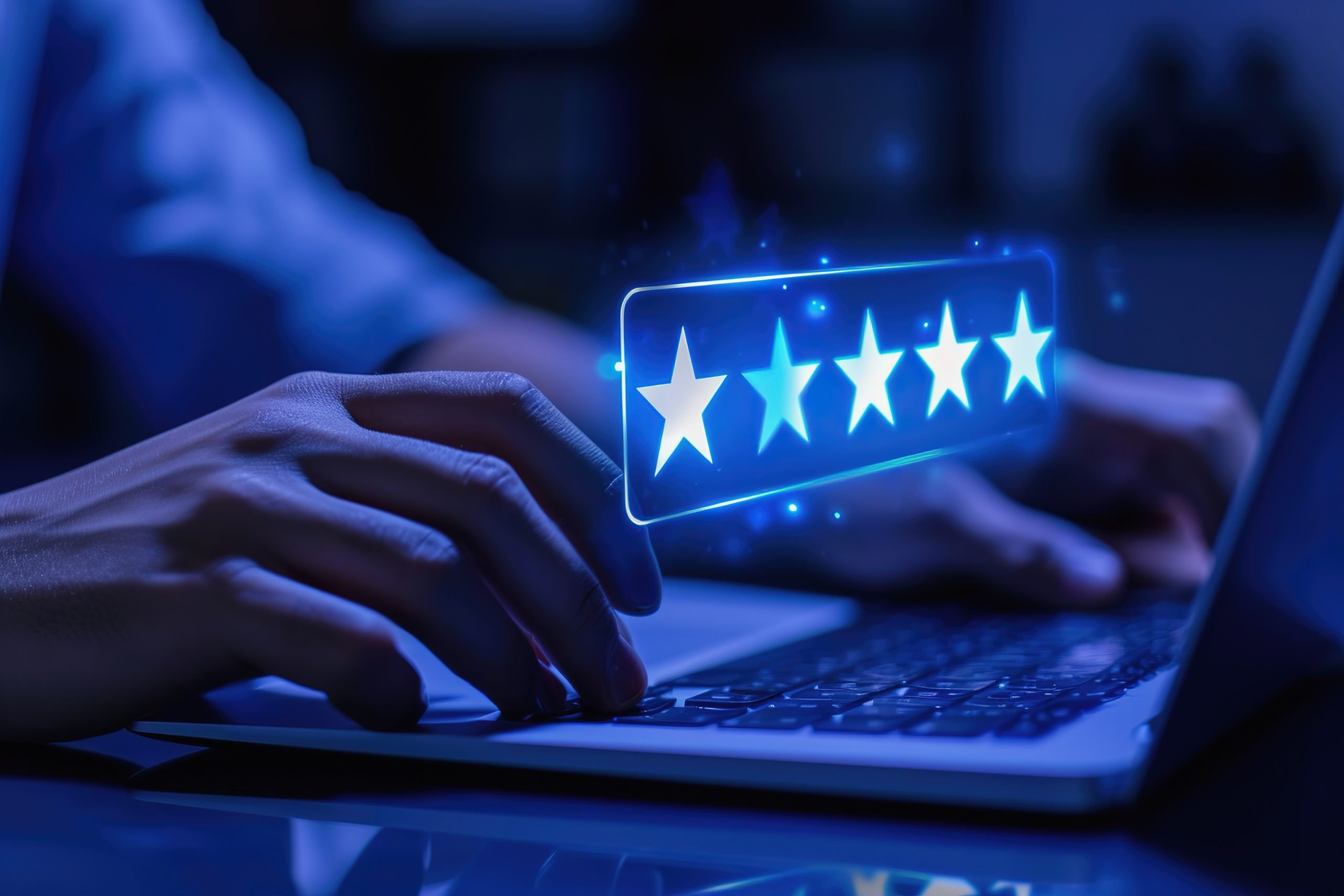 Man with laptop selecting a five star review